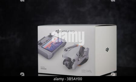 DJI Mini 4 Pro drone box featuring remote controller and folded drone - FRANKFURT, GERMANY - MAY 02, 2025 Stock Photo