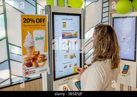 Okeechobee Florida,Highway 441,McDonald's fast food hamburger restaurant,inside interior,self-service ordering kiosk,touchscreen menu,20% percent off Stock Photo