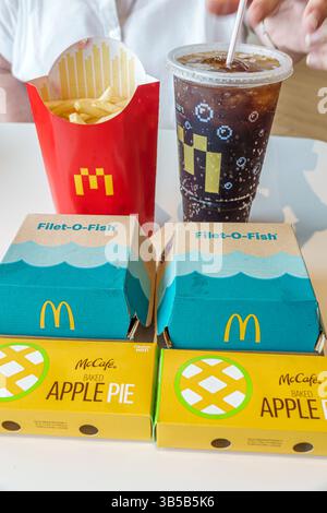 Okeechobee Florida,Highway 441,McDonald's fast food hamburger restaurant,inside interior,table meal display,Filet-O-Fish sandwiches,McCafe baked apple Stock Photo