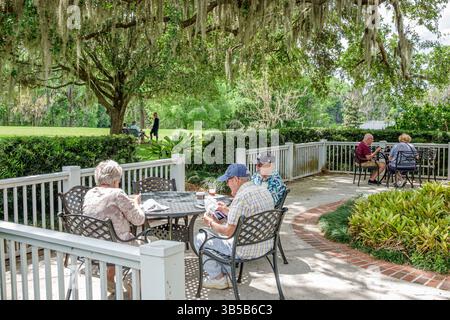 Orlando Florida,Harry P Leu Gardens,botanical garden,senior man men woman couple,sitting outdoor patio,courtyard terrace seating,people relaxing,eatin Stock Photo