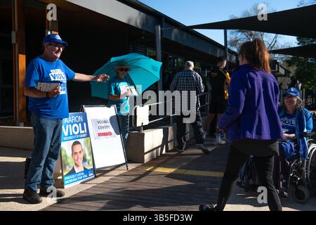 Voters line up before a polling site opens to cast their ballots in ...