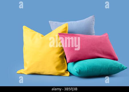 Different colorful pillows on blue background Stock Photo