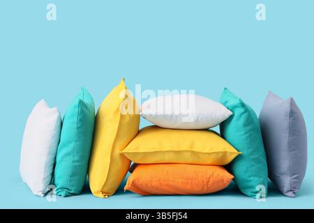 Different colorful pillows on blue background Stock Photo