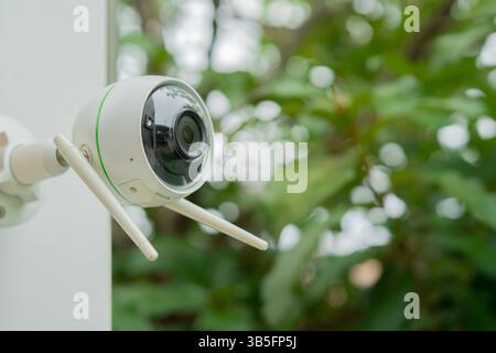 CCTV Security Camera or surveillance system. Security camera installed in the garden of a house. Copy space, selective focus. Stock Photo