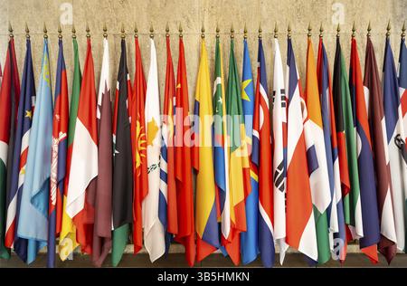 Some world national flags on poles on a wall Stock Photo - Alamy