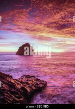 Sunset at Cape Kiwanda beach with Haystack Rock, Oregon. Stock Photo