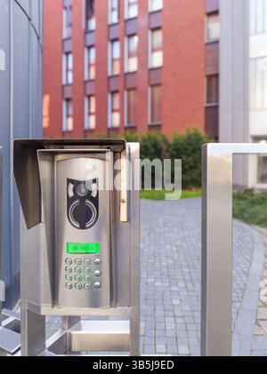 Modern video intercom system at gated entrance Stock Photo