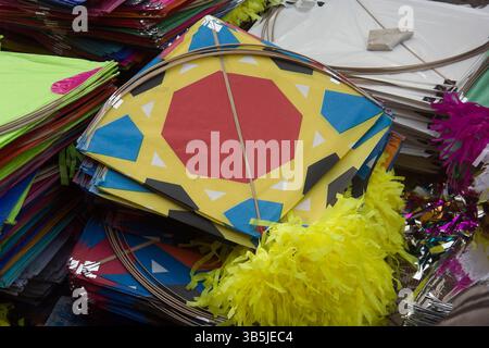 Vadodara, Gujarat / India - January 12, 2017 : Closeup view of the pile of colorful kites for sell on the street in the kite market. Stock Photo