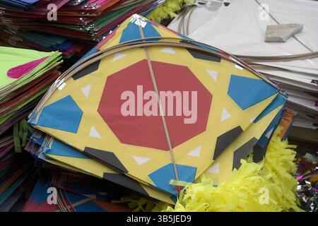 Vadodara, Gujarat / India - January 12, 2017 : Closeup view of the pile of colorful kites for sell on the street in the kite market. Stock Photo