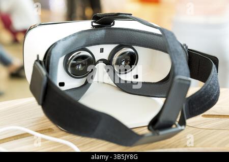 Virtual reality (VR) headsets (glasses) from behind. VR is immersive multimedia or computer-simulated reality - a computer technology that replicates Stock Photo
