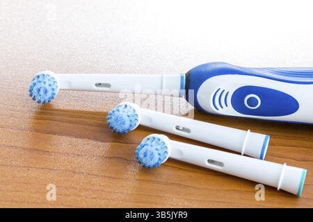 Electronic toothbrush with toothbrush heads on a table Stock Photo