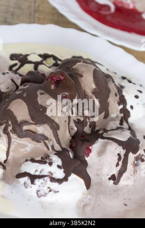 Chocolate ice cream on the table raspberry dressing Stock Photo