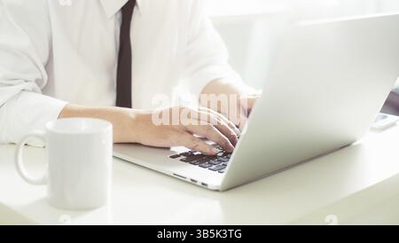 Businessman hands working on laptop, Blurred background Stock Photo
