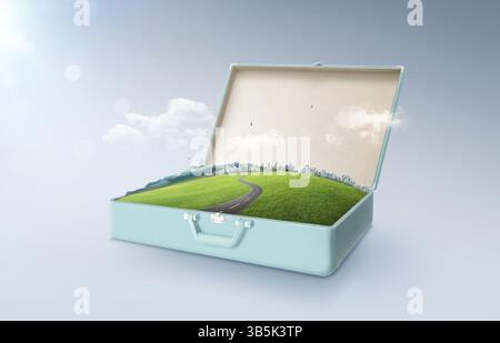 City skyline, green field, mountain and curvy asphalt highway in an open retro vintage suitcase isolated on light blue background Stock Photo