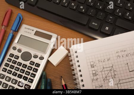 Computer keyboard, colorful pencils, eraser and notebook on the table Stock Photo