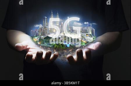 Unknown hand holding fantasy island floating in the air with 5G network wireless systems, Smart city and communication network concept Stock Photo