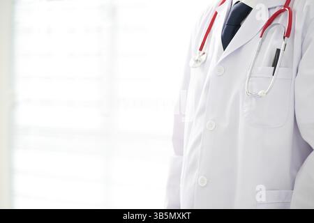 Unknown doctor posing in the office, he is wearing a stethoscope Stock Photo