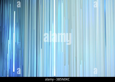 Light blue vertical stripes hanging and creating a modern abstract background Stock Photo