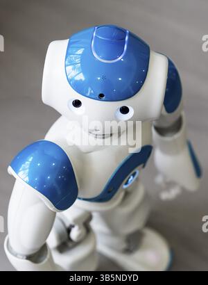 A small robot with human face and body - humanoid. Artificial Intelligence - AI. Blue robot Stock Photo