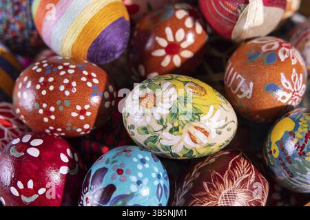 Close-up view from above. Randomly stacked close together, the Easter eggs form a colorful Easter composition while tightly filling the entire frame Stock Photo