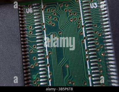 Electronic circuit pattern. Microelectronic and semiconductor components. Electronic texture on printed circuit board. Stock Photo