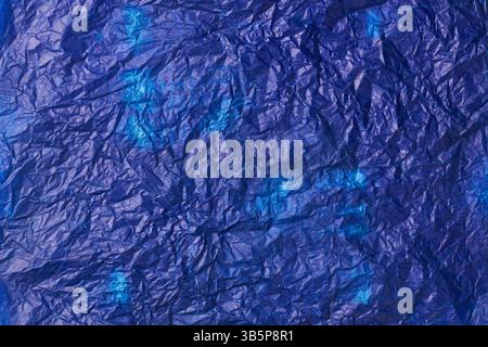 crumpled used blue carbon paper surface background, navy blue tone waxy or oily wrinkled thin sheet in full frame, textured backdrop of copy space Stock Photo