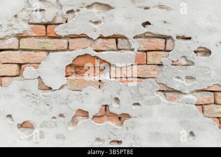 Damaged Plaster Wall Revealing Old Bricks Stock Photo