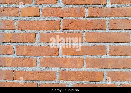 Evenly Laid Red Brick Wall with Gray Mortar Stock Photo