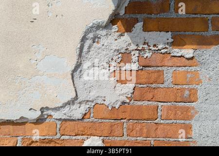 Exposed Brick Wall with Peeling Plaster Texture Stock Photo