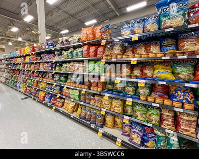 Variety of Chips and snacks for sale on the shelves in a supermarket. Alberta, Canada. Stock Photo