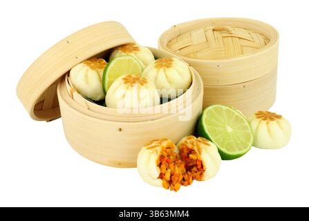 Oriental steamed dumplings in a traditional bamboo steamer isolated on a white background Stock Photo