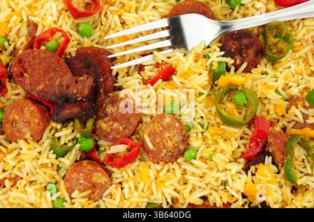 Egg fried rice with spicy chorizo salami and Chilli peppers background Stock Photo