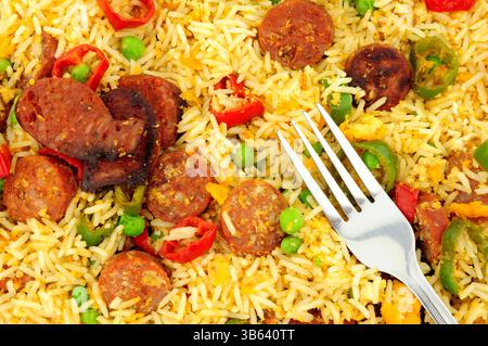 Egg fried rice with spicy chorizo salami and Chilli peppers background Stock Photo