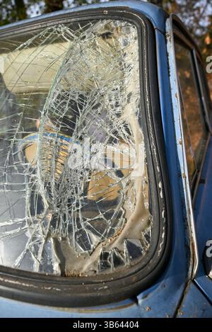Close-up of the broken windshield of an old car in an accident Stock Photo