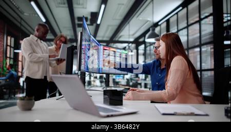 African American Man Codes Medical Invoices On Office Computers. Stock Photo