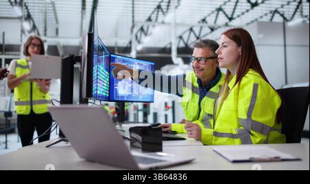 Young African American Engineer Using SCADA System At Industrial Plant. Stock Photo
