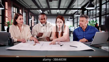 Design Team Collaborating On Home Remodeling Project In Modern Office. Stock Photo
