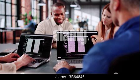 Collaborative Coding Session In Tech Startup With Multiracial Programmers Working Stock Photo
