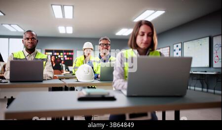 Young African American Engineer Operates Laptop In Diverse Classroom Group. Stock Photo