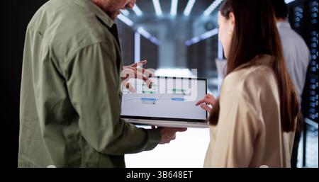 Diverse Team Of Engineers Using Node Editor For Data Center Configuration Stock Photo