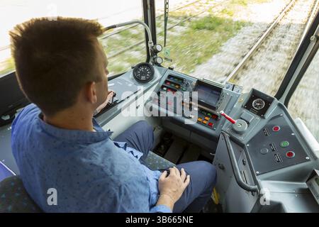 Sofia, Bulgaria - 28 June, 2017: Public transport driver drives city tram car during a test drive on new tramway cars for journalists Stock Photo