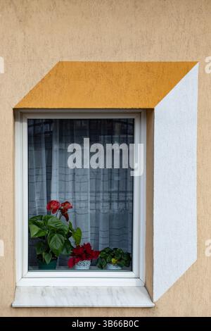 Painted decorative perspective geometric design on a window on a beige wall Stock Photo