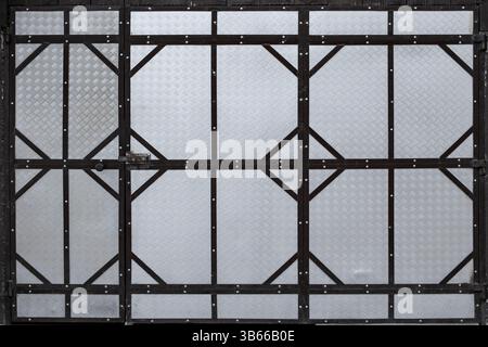 Garge door made of welded metal sheets and black steel frame, full frame  template Stock Photo