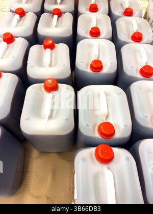 Rows of red plastic containers filled with enriched humus ready for ...