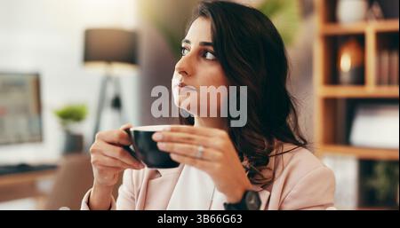 Business, coffee and thinking with Indian woman in office for future, planning or vision of company. Decision, development and ideas with employee Stock Photo