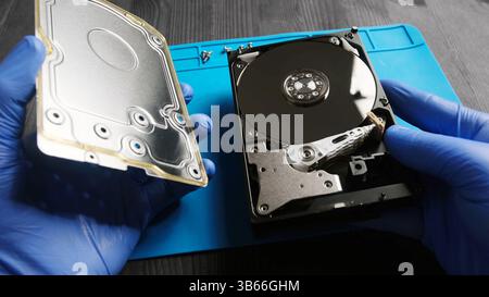 repairman fixing computer hard disk drive in service center Stock Photo