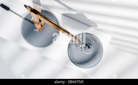Retro or vintage style desk lamp, classic wooden arm with metal base and grey colored canopy, against white background, isolated. Stock Photo