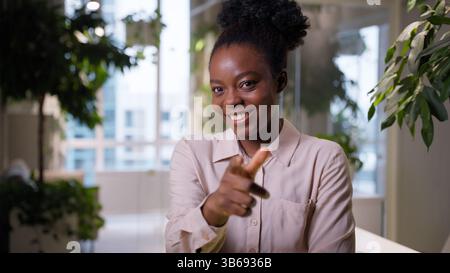 Thoughtful African American ethnic business woman student manager thinking businesswoman girl employer think ponder dream in office pointing finger Stock Photo