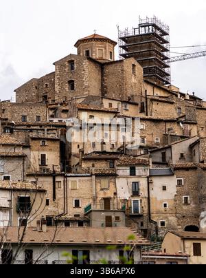 A picturesque view of a historic village with stone buildings stacked on a hillside. The architecture features a mix of old and new, with scaffolding Stock Photo