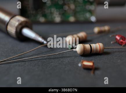 Electronics work bench. Focused on electrical resistor. Stock Photo